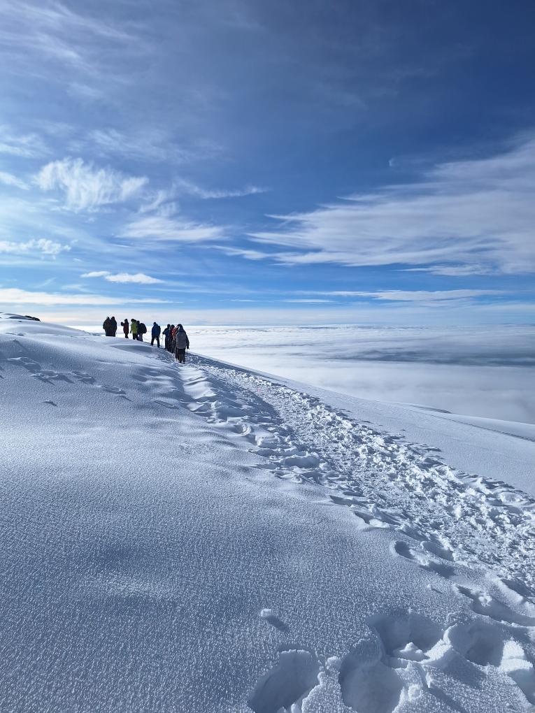 Climbers trekking on snowy ridge Mount Kilimanjaro
